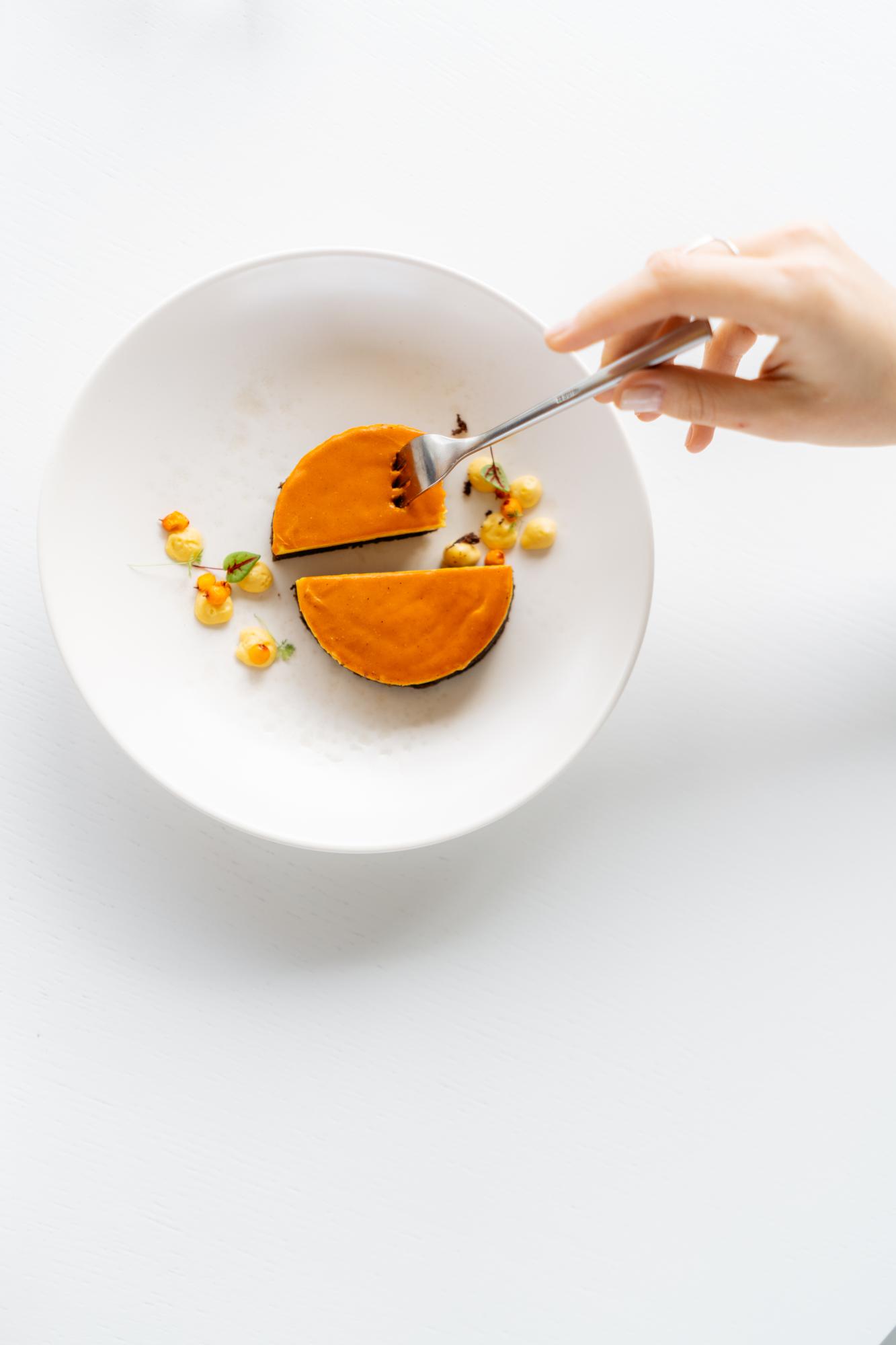 Close-up on hands plating a dessert